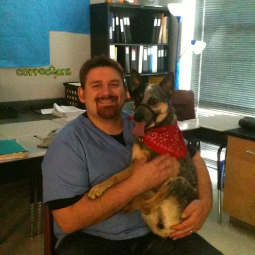 Staff member holding dog 